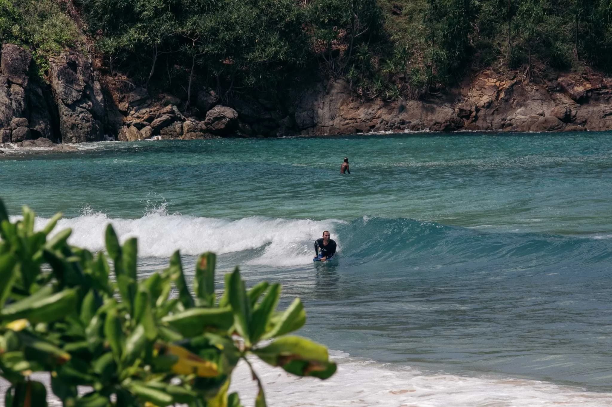 A bodyboarder making the most of the smaller swell in Nai Harn